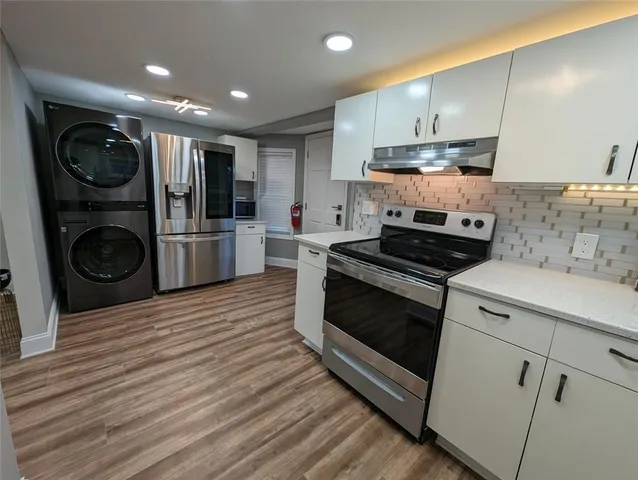 a kitchen with a stove a sink and a refrigerator