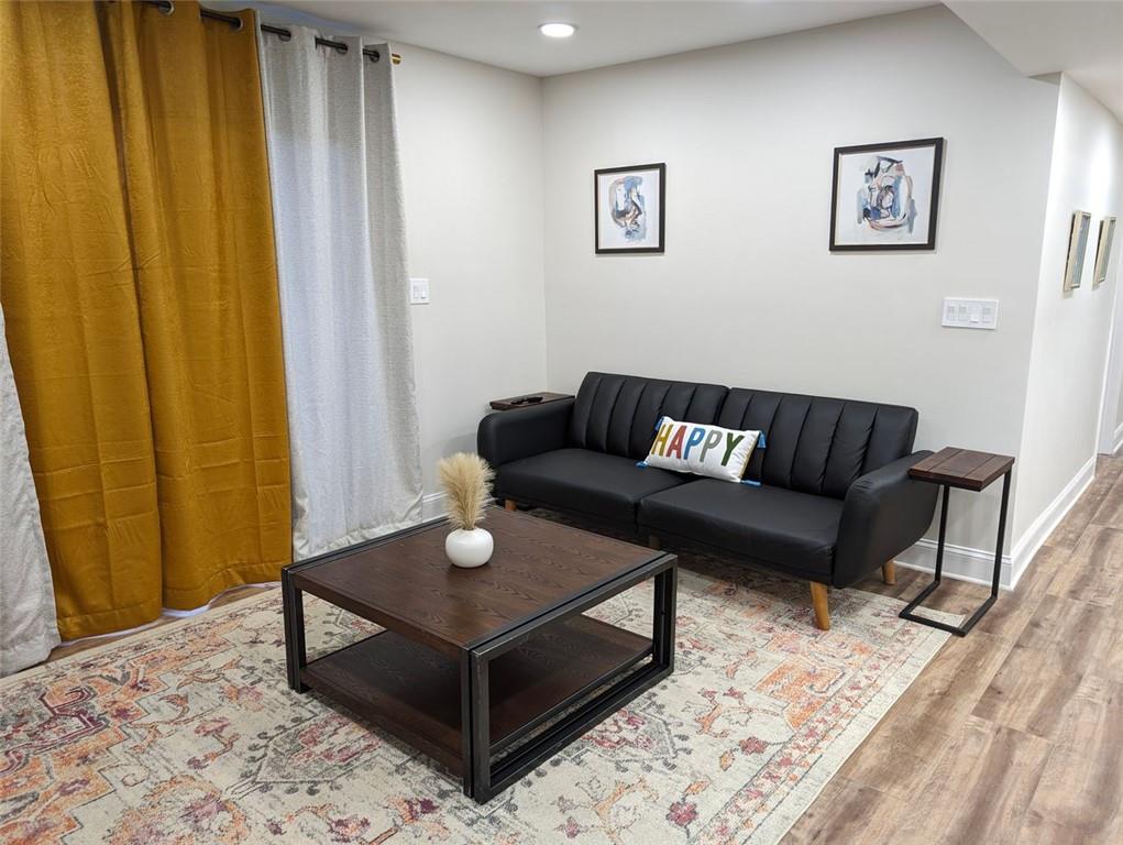 1303 Colony Drive, Unit C Marietta, GA 30068 - Photo 16 of 18 a living room with furniture and a wooden floor