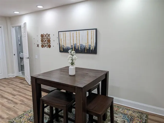 a view of a room with a table and chairs