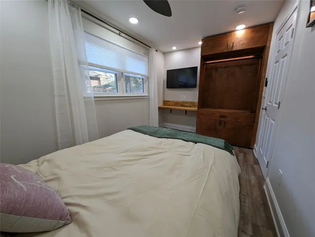 a bedroom with a bed and a television