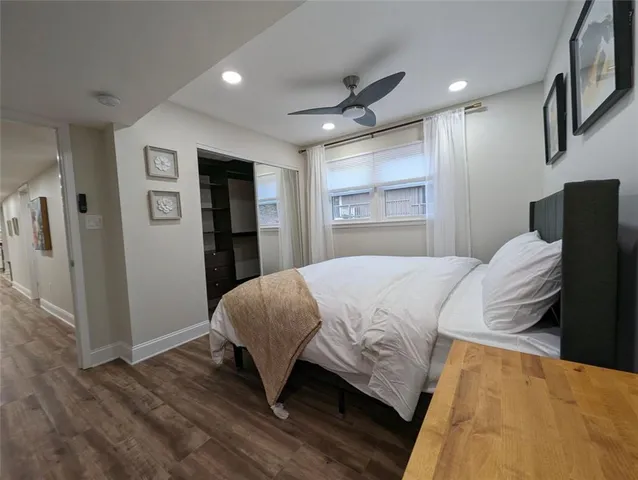 a bedroom with a bed and a large mirror