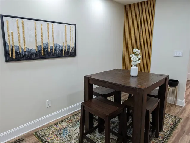 a view of a room with furniture and wooden floor
