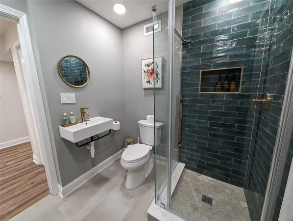 a bathroom with a toilet a sink and mirror