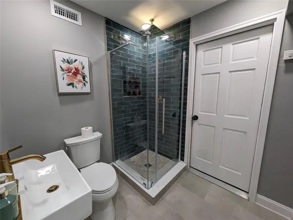 a bathroom with a toilet and shower