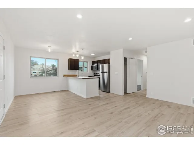 a view of kitchen with stainless steel appliances a refrigerator and a sink