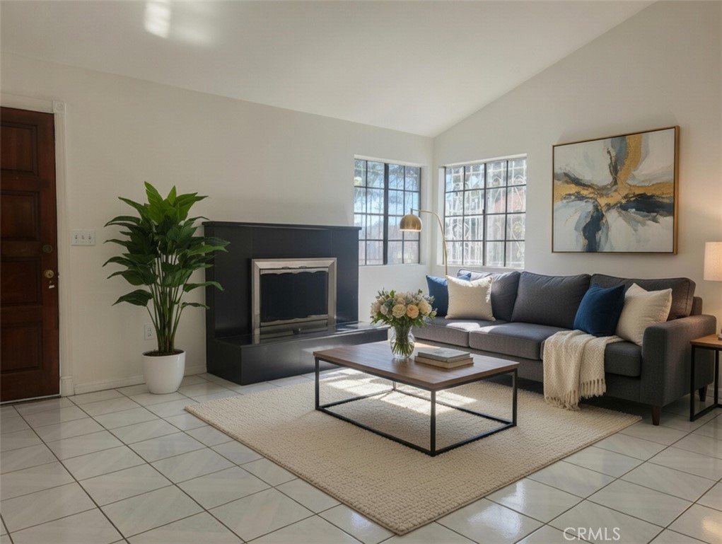 12729 Judd Street Pacoima, CA 91331 - Photo 3 of 14 a living room with furniture a potted plant and a fireplace