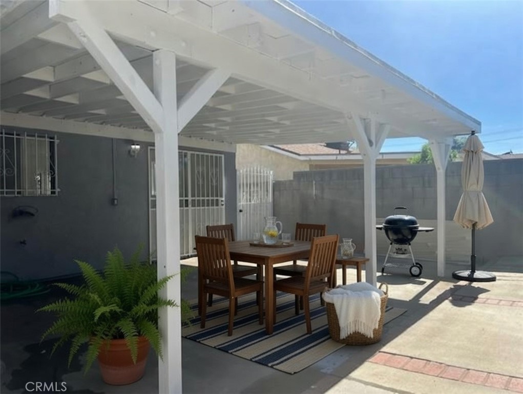 12729 Judd Street Pacoima, CA 91331 - Photo 9 of 14 a dining room with furniture and wooden floor