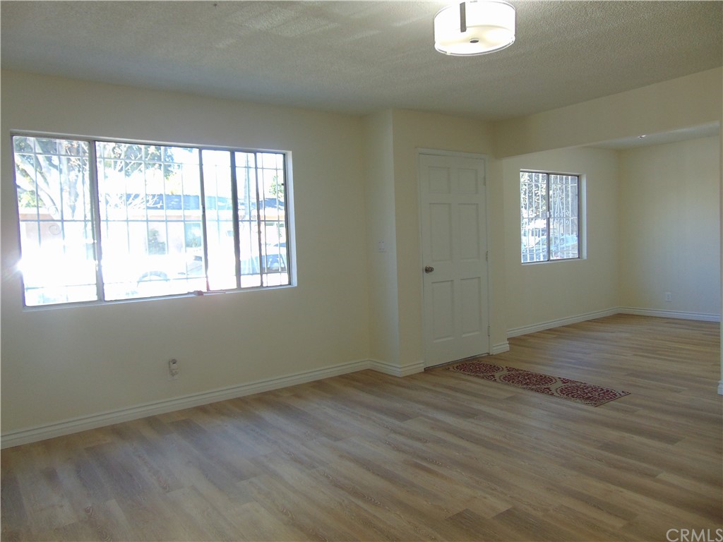 420 West 67th Way Long Beach, CA 90805 - Photo 17 of 21 an empty room with wooden floor and windows