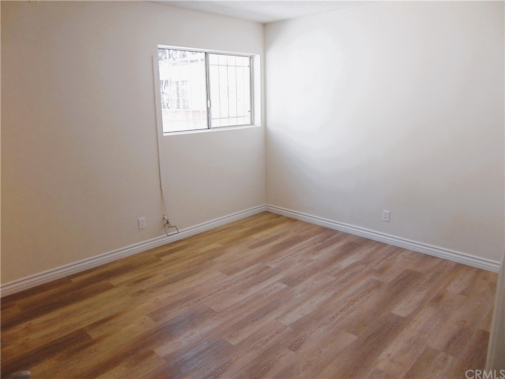420 West 67th Way Long Beach, CA 90805 - Photo 19 of 21 an empty room with wooden floor and windows
