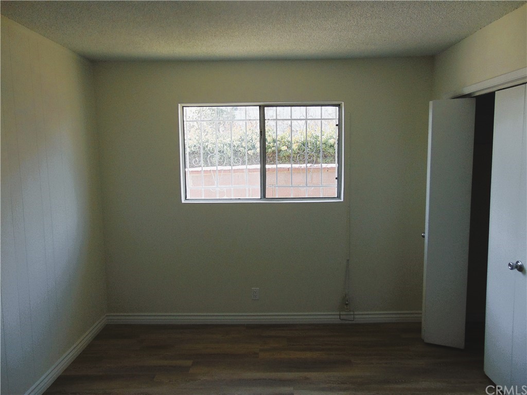 420 West 67th Way Long Beach, CA 90805 - Photo 21 of 21 an empty room with wooden floor and windows