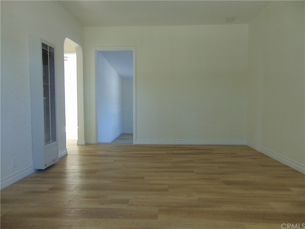 420 West 67th Way Long Beach, CA 90805 - Photo 3 of 21 a view of an empty room with wooden floor and a window