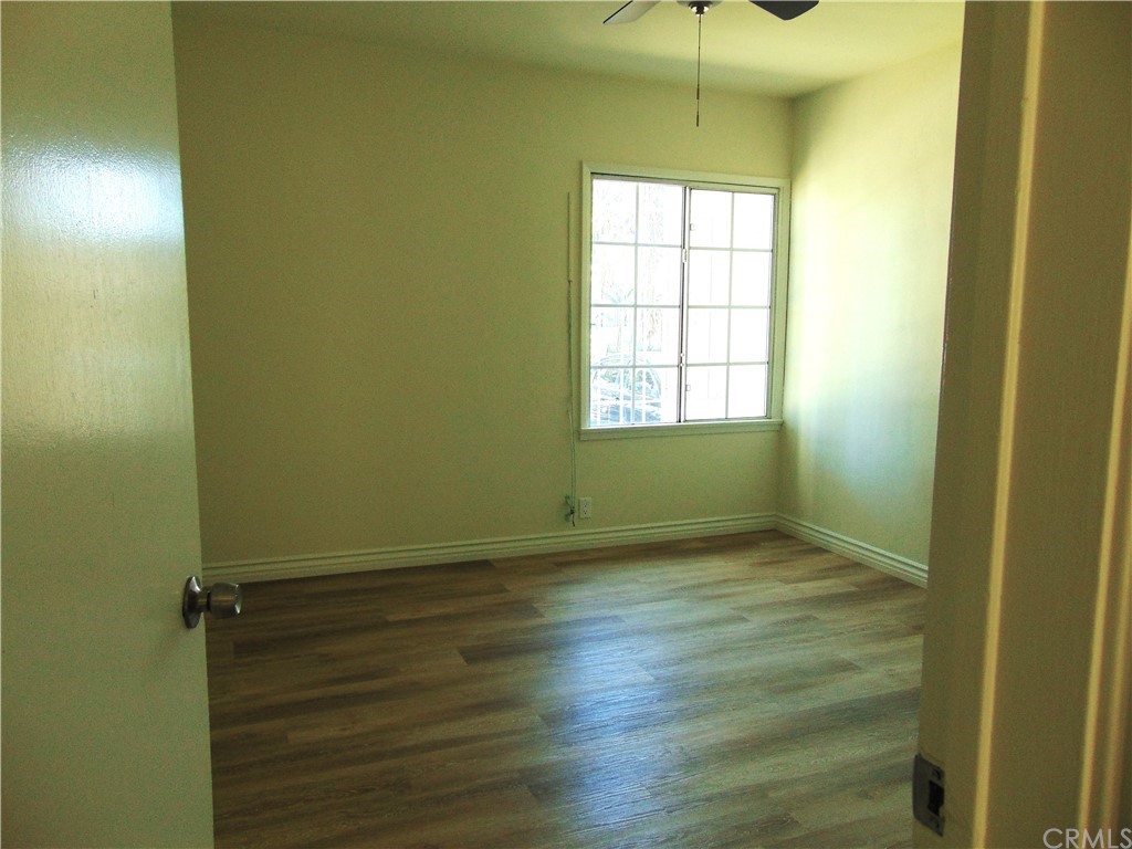420 West 67th Way Long Beach, CA 90805 - Photo 5 of 21 a view of an empty room with wooden floor and a window