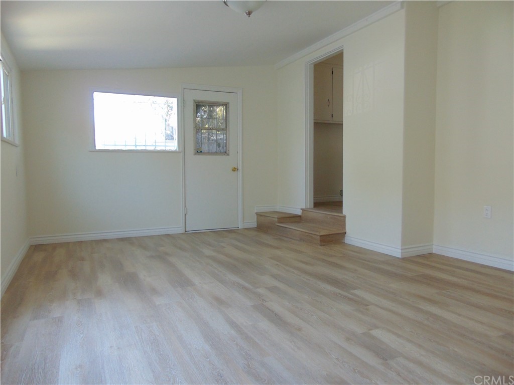 420 West 67th Way Long Beach, CA 90805 - Photo 7 of 21 an empty room with wooden floor and windows