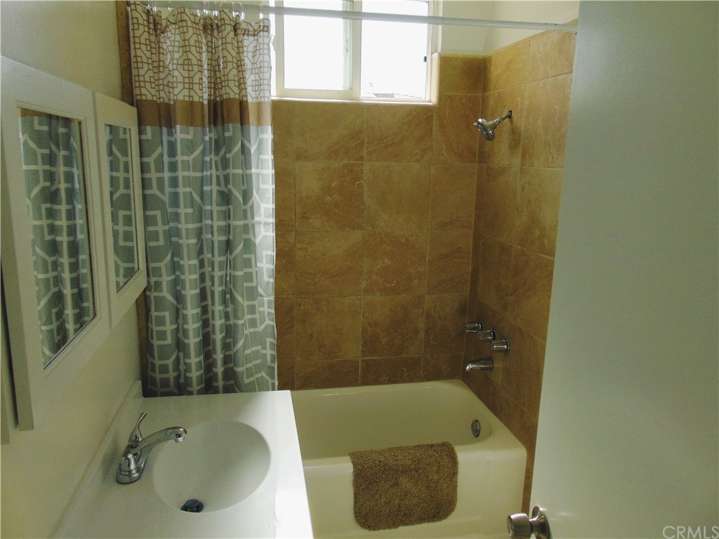 420 West 67th Way Long Beach, CA 90805 - Photo 8 of 21 a bathroom with a tub and shower