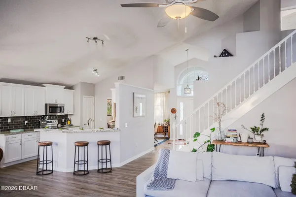 a living room with kitchen island furniture and kitchen view