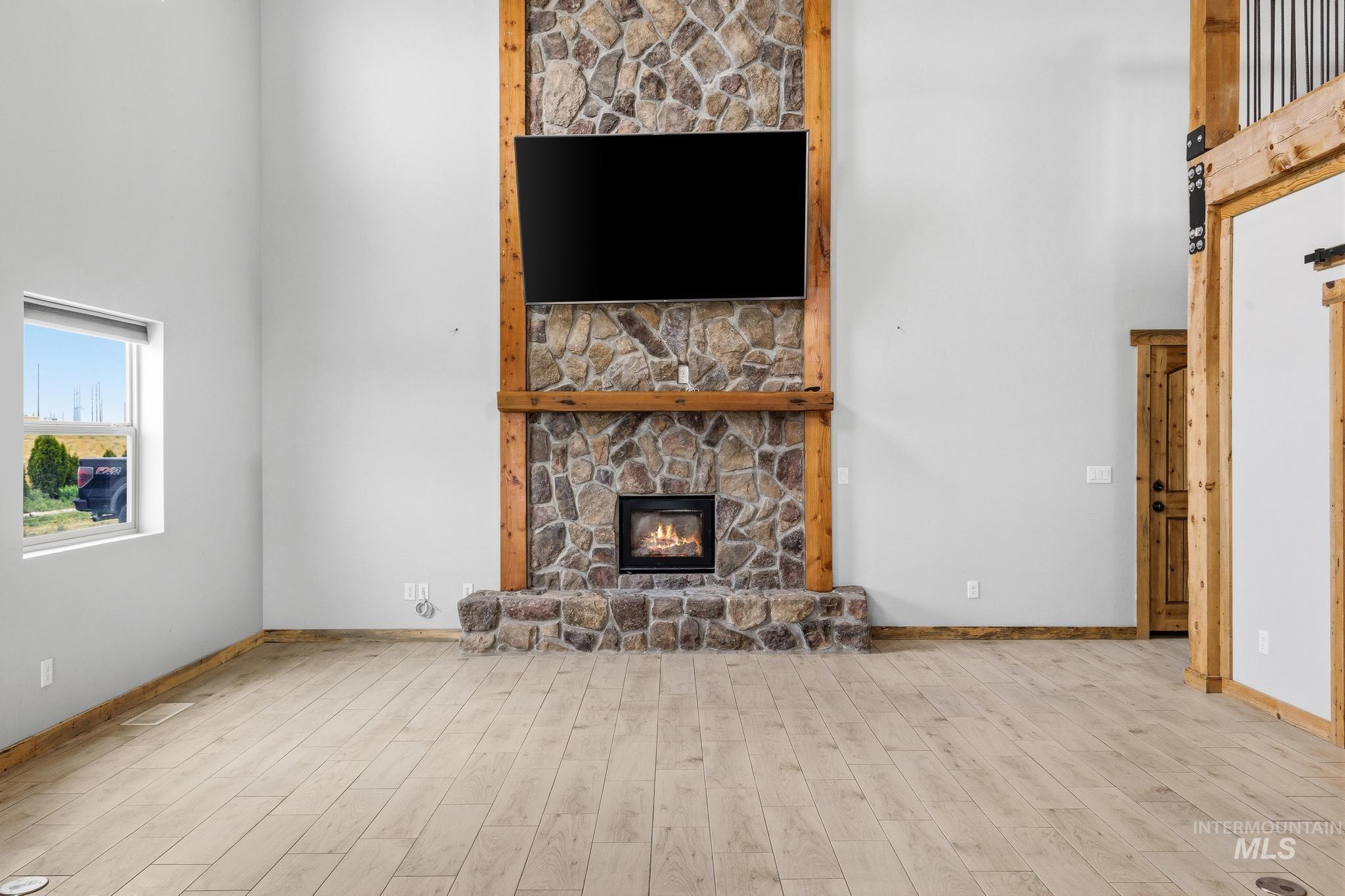870 Desert Wind Road Boise, ID 83716 - Photo 12 of 50 Spacious utility area featuring white shaker cabinetry, dark countertops, a subway tile backsplash with mosaic accents, and wood-finish flooring