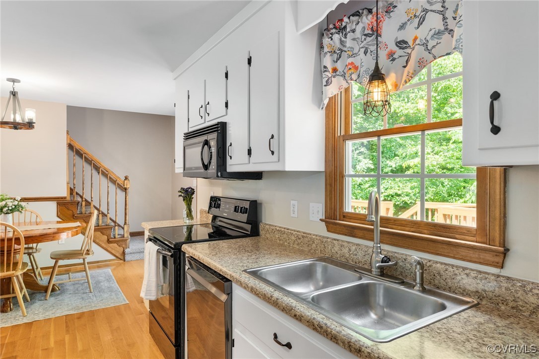 12207 Balta Road Chesterfield, VA 23838 - Photo 16 of 50 Kitchen with black appliances, a sink, a chandelie