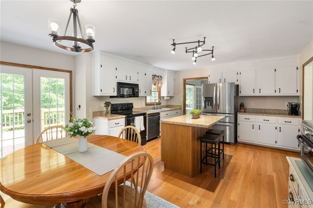 12207 Balta Road Chesterfield, VA 23838 - Photo 20 of 50 Kitchen featuring black appliances, a chandelier,