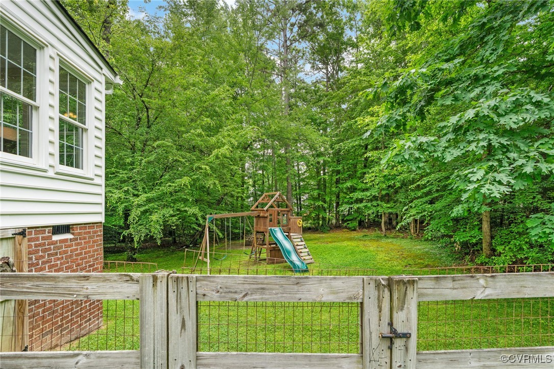 12207 Balta Road Chesterfield, VA 23838 - Photo 40 of 50 View of green lawn featuring a playground