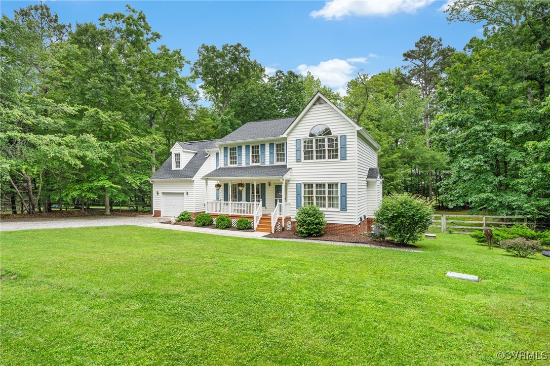 Colonial inspired home with covered porch, gravel