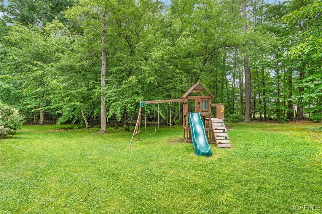 12207 Balta Road Chesterfield, VA 23838 - Photo 41 of 50 View of play area with a yard and a forest view