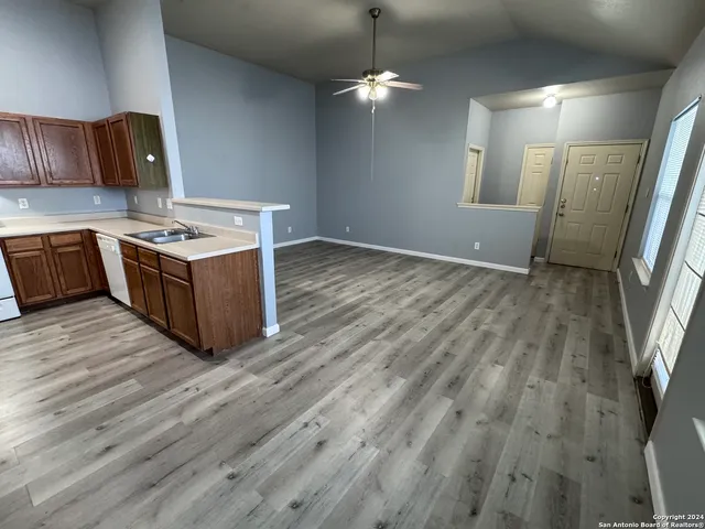 a kitchen with stainless steel appliances granite countertop a sink stove and wooden floor