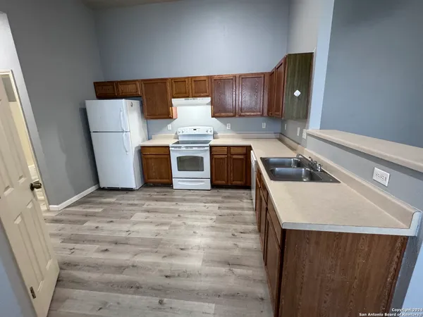 a kitchen with a stove and a refrigerator