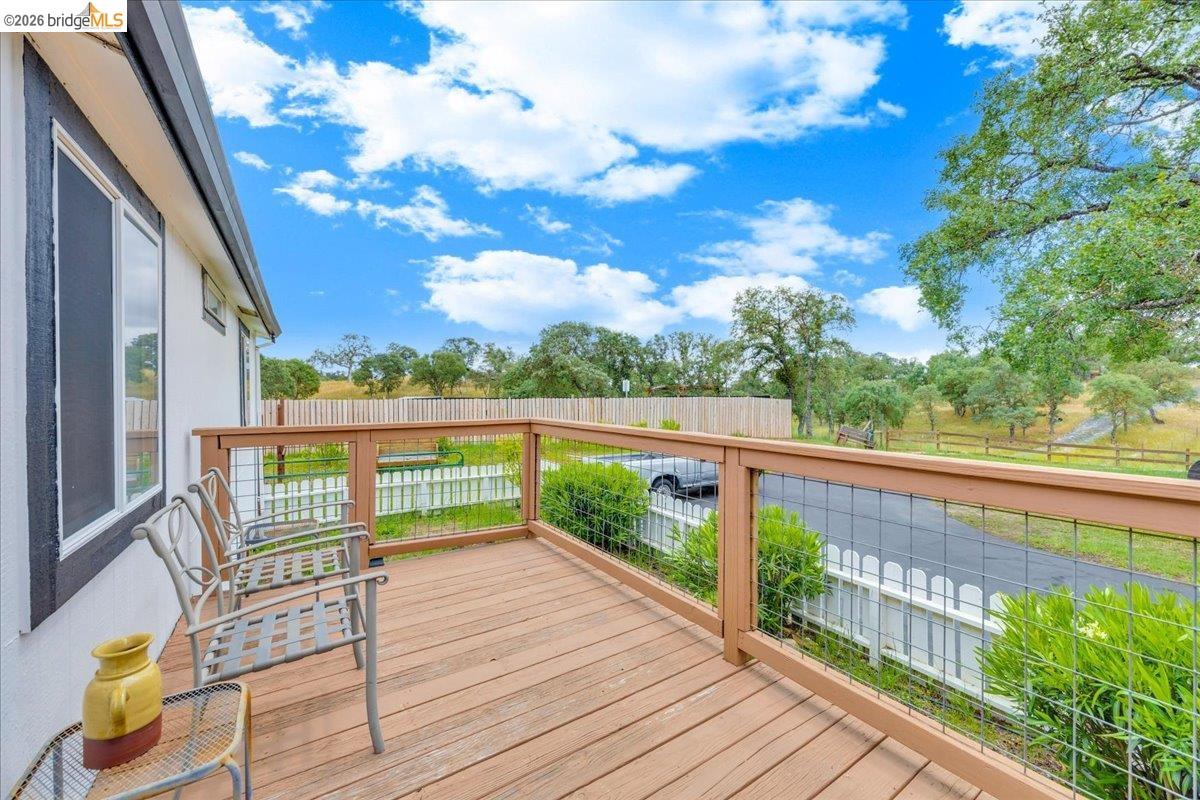 4419 Little John Road Copperopolis, CA 95228 - Photo 39 of 43 Exterior deck featuring wood-finish flooring and a wood railing with metal infill