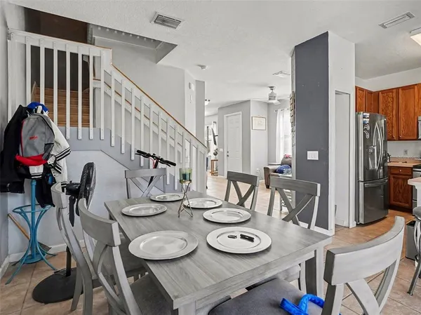 a dining room with furniture and wooden floor