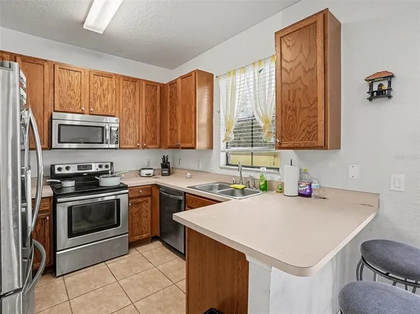 a kitchen with a stove a sink and a microwave