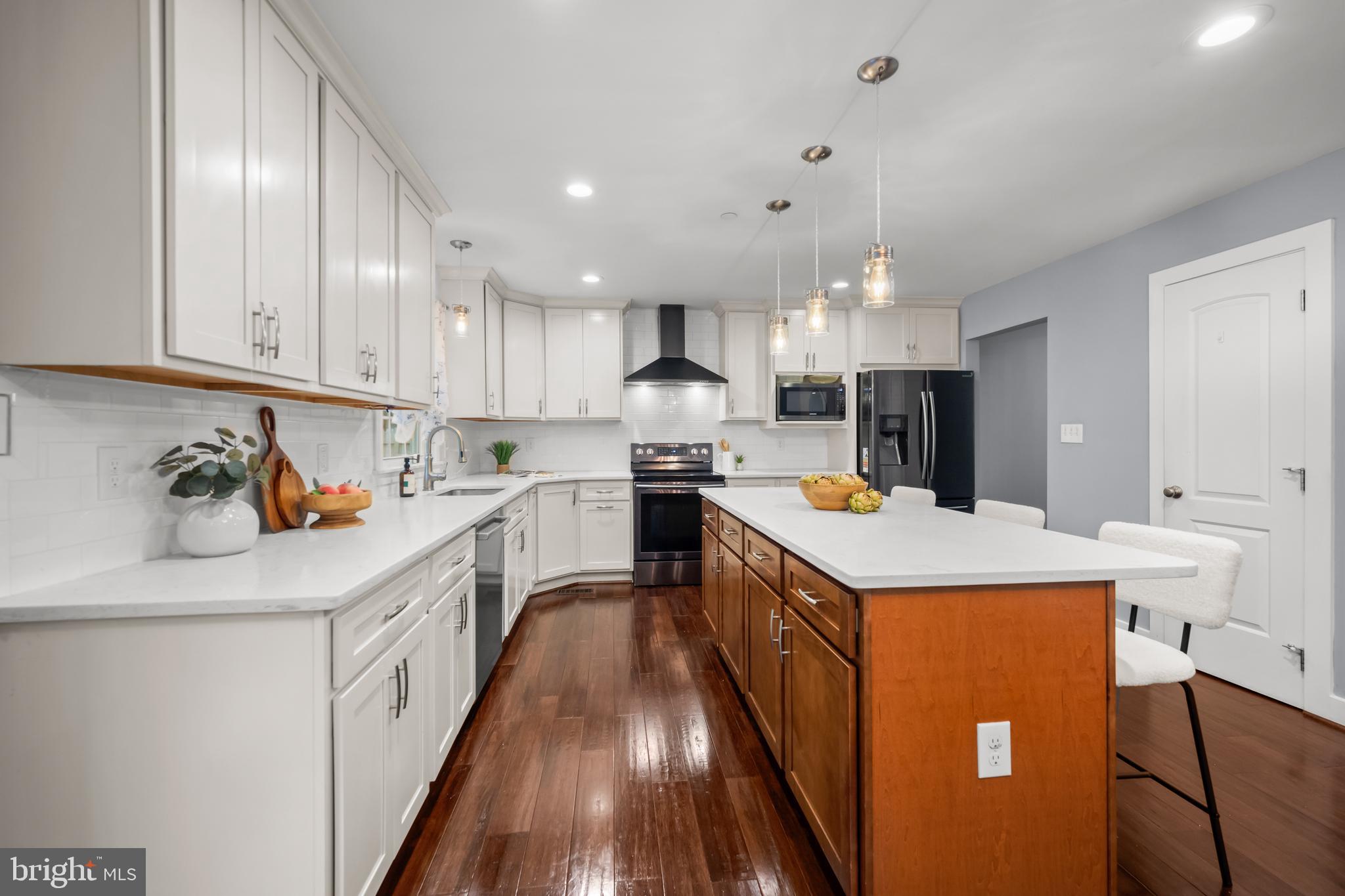 3319 Mail Road Westminster, MD 21157 - Photo 16 of 70 a kitchen with kitchen island wooden cabinets and white appliances