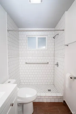 a bathroom with a shower and a toilet
