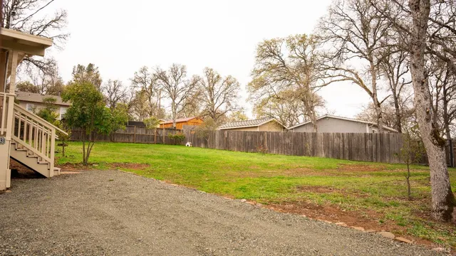 a view of a yard with a house in the background
