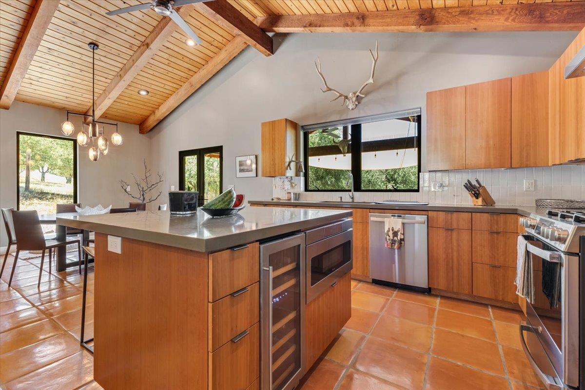 2727 Thomas Road Hollister, CA 95023 - Photo 52 of 83 a kitchen with stainless steel appliances granite countertop a sink a stove and a wooden cabinets