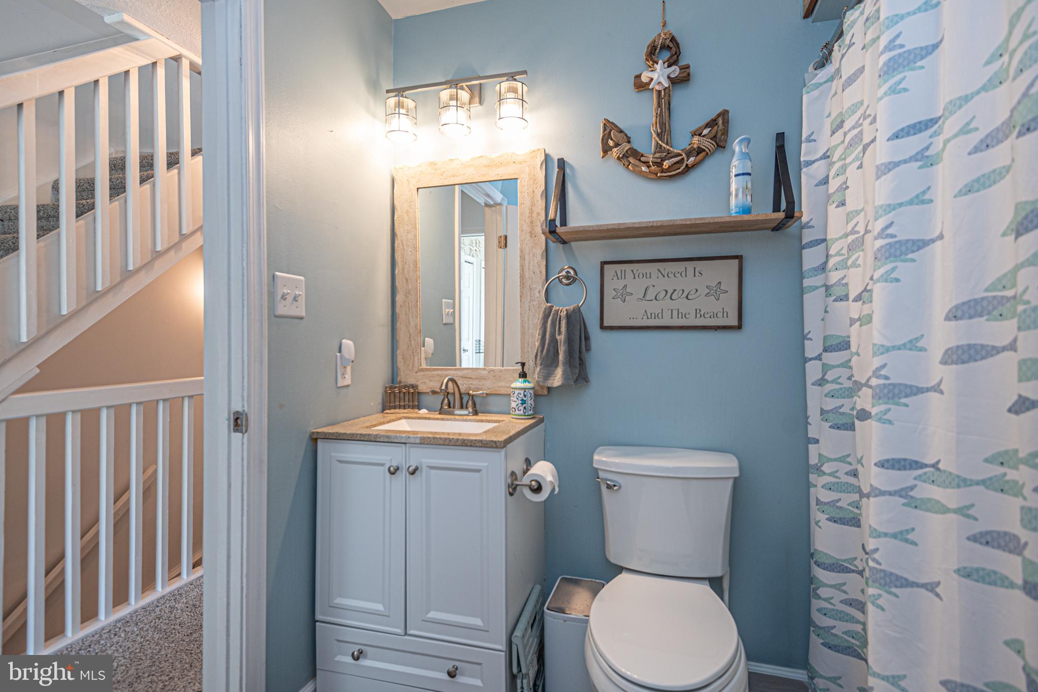 702 Bradley Road, Unit 11 Ocean City, MD 21842 - Photo 13 of 92 a bathroom with a toilet a sink and a mirror