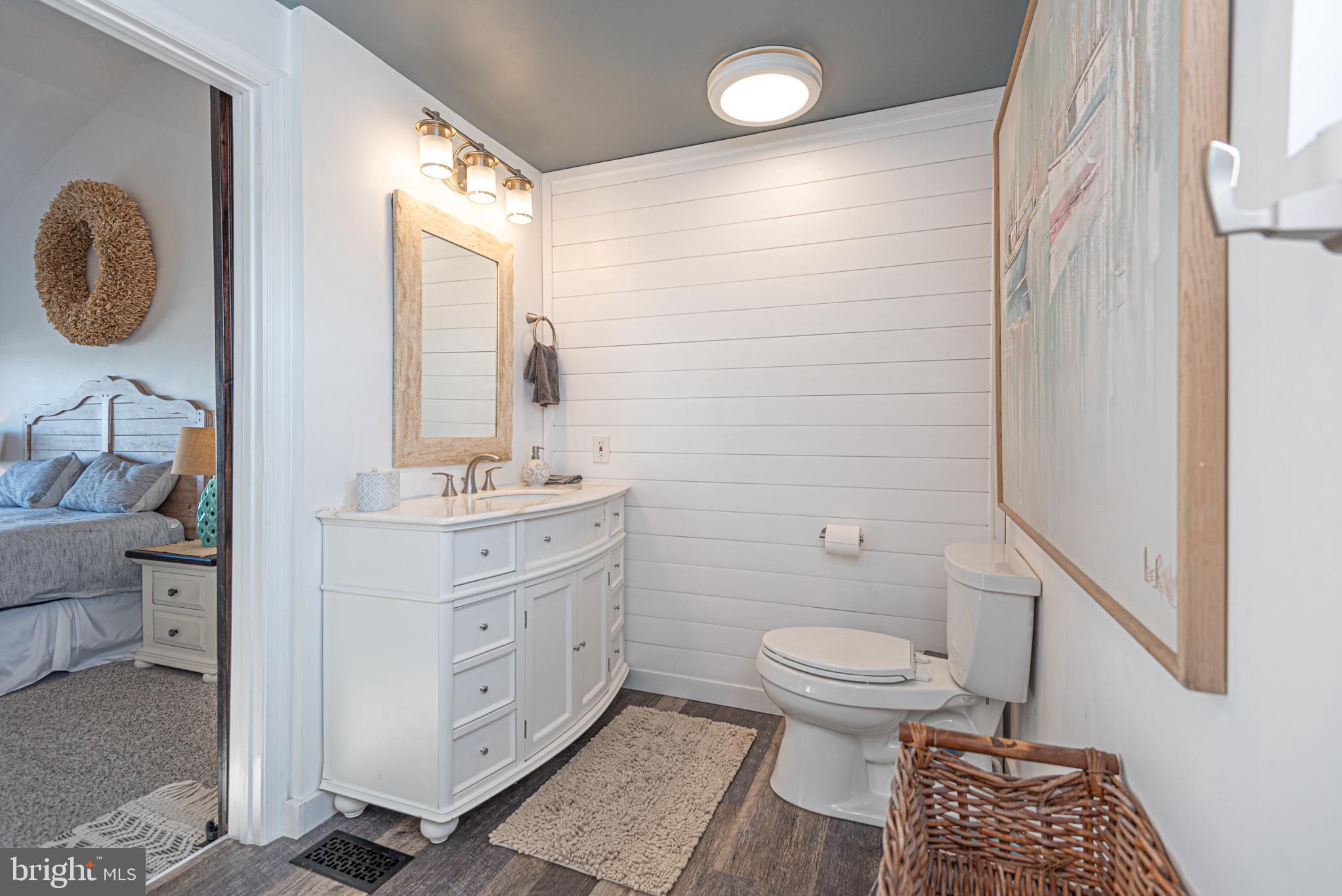 702 Bradley Road, Unit 11 Ocean City, MD 21842 - Photo 16 of 92 a bathroom with a toilet a sink and a mirror