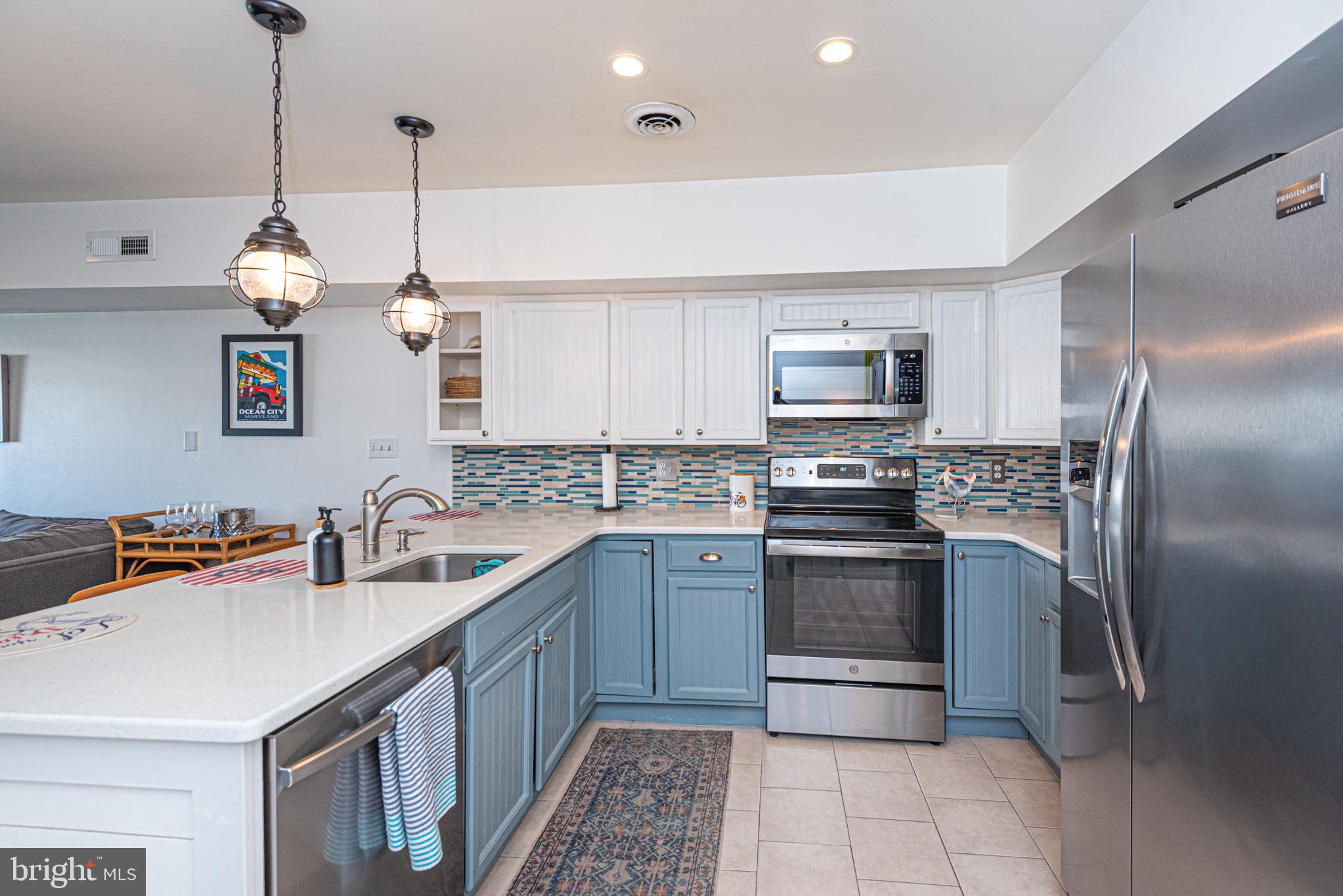 702 Bradley Road, Unit 11 Ocean City, MD 21842 - Photo 24 of 92 a kitchen with stainless steel appliances granite countertop a sink a stove and a refrigerator