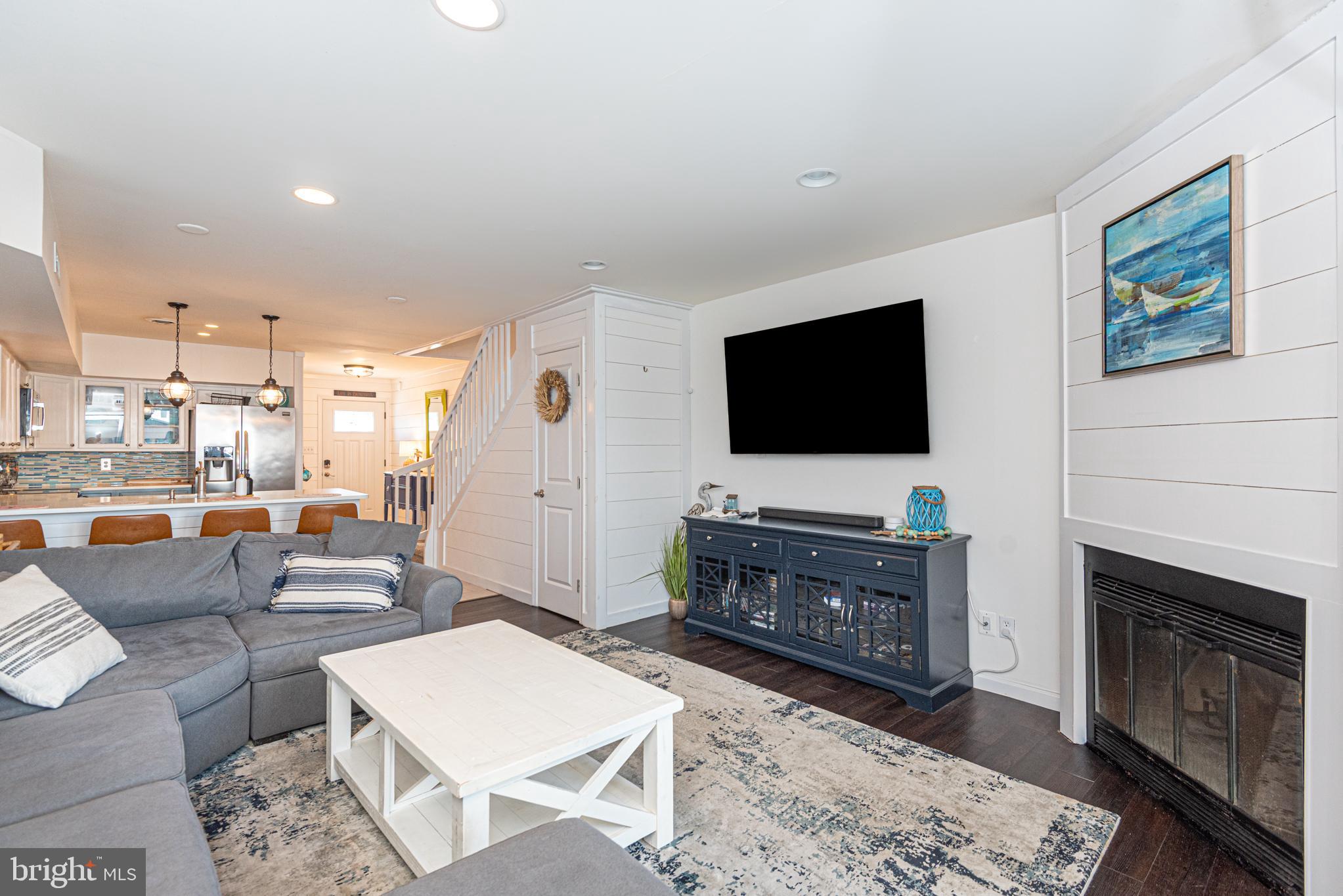 702 Bradley Road, Unit 11 Ocean City, MD 21842 - Photo 28 of 92 a living room with furniture and a flat screen tv