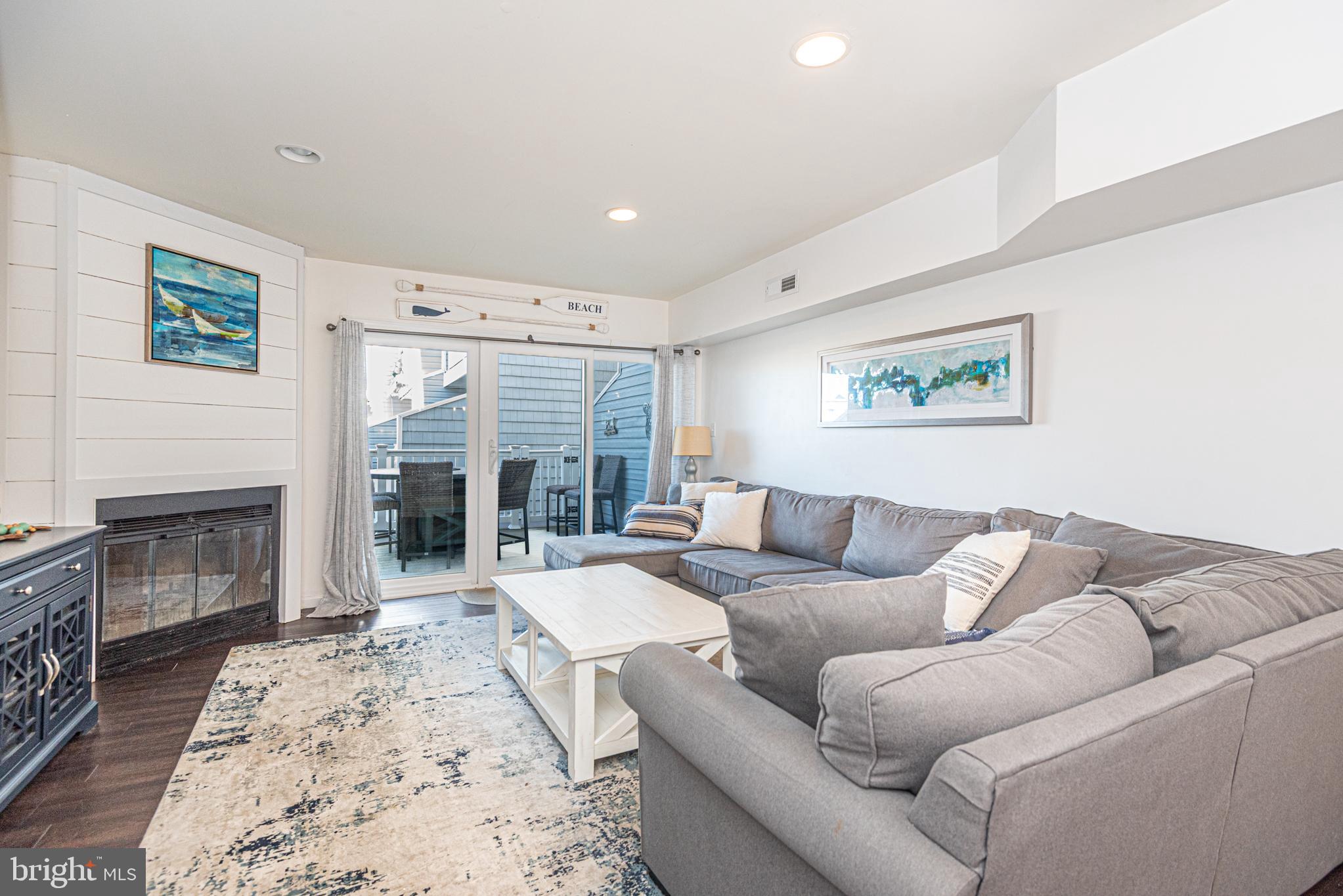 702 Bradley Road, Unit 11 Ocean City, MD 21842 - Photo 31 of 92 a living room with furniture large window and a fireplace