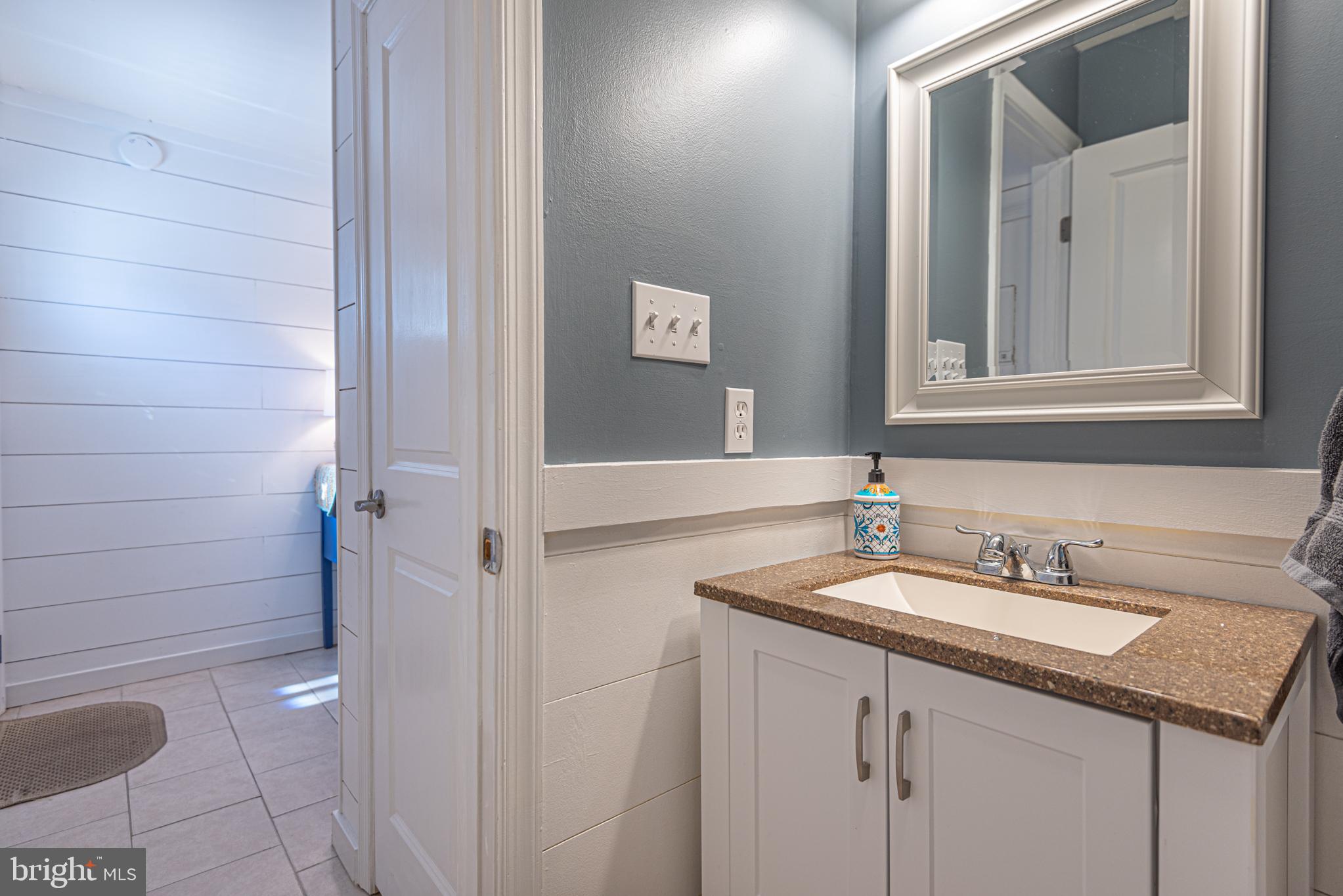702 Bradley Road, Unit 11 Ocean City, MD 21842 - Photo 36 of 92 a bathroom with a sink and a mirror