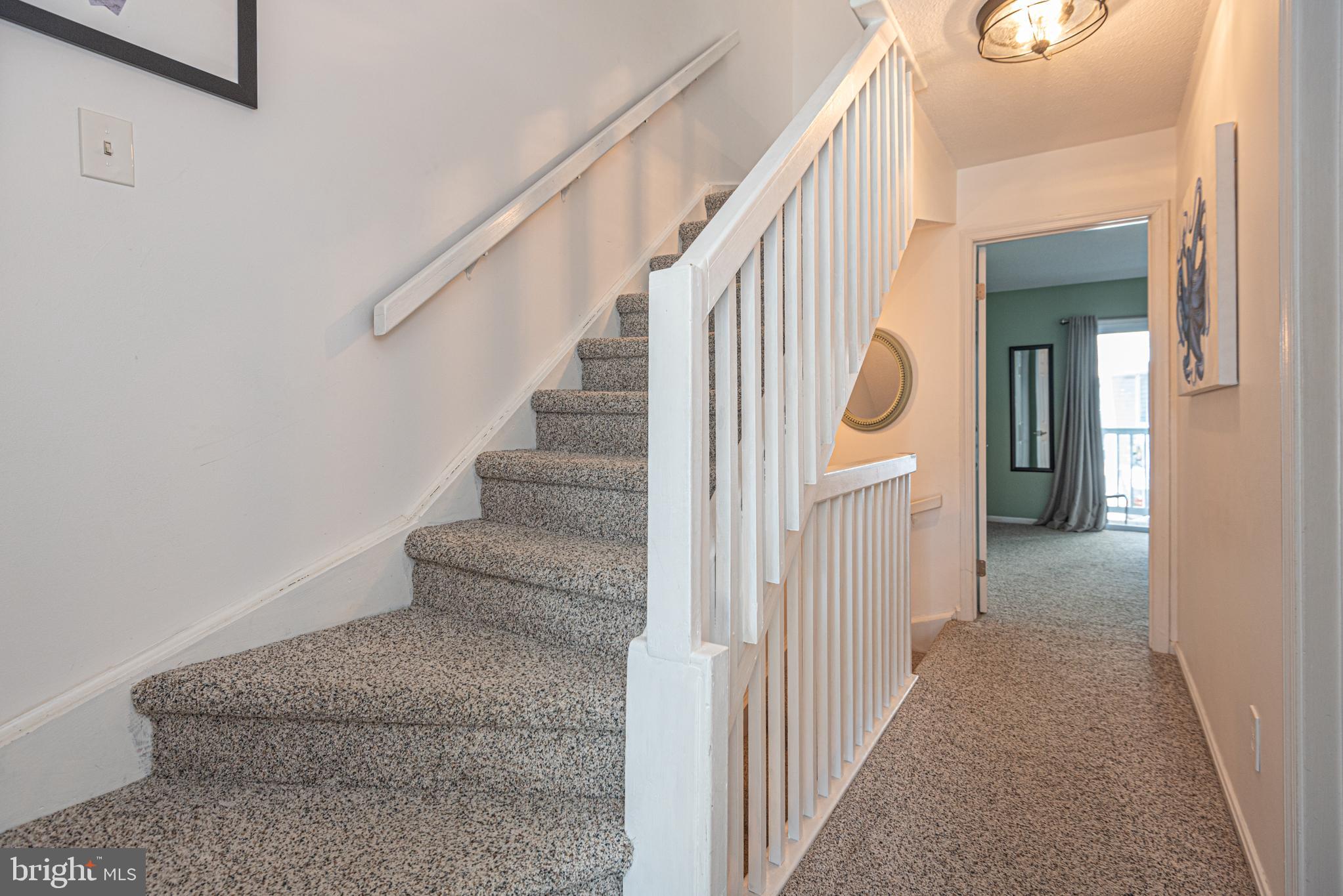 702 Bradley Road, Unit 11 Ocean City, MD 21842 - Photo 41 of 92 a view of a hallway with staircase