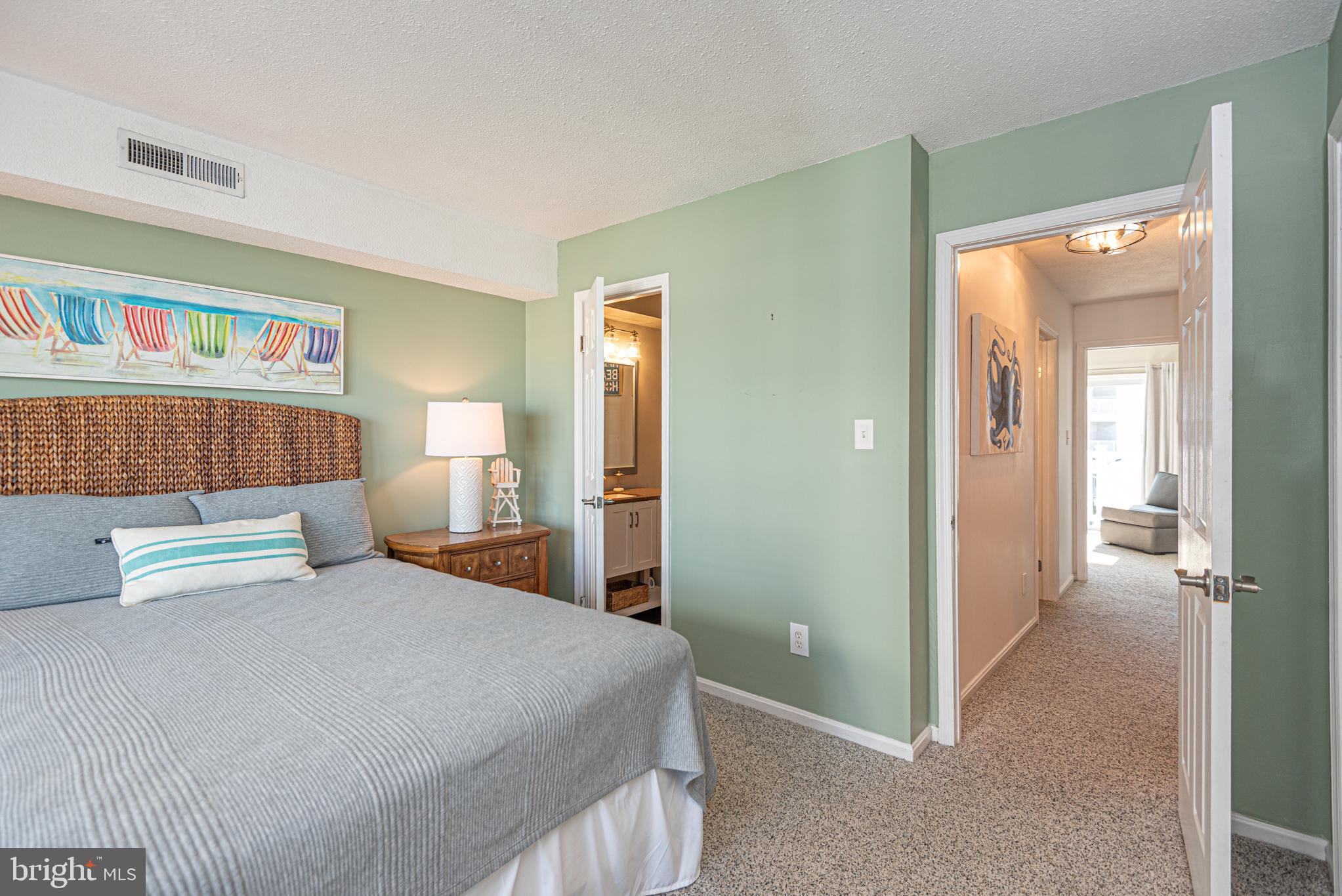 702 Bradley Road, Unit 11 Ocean City, MD 21842 - Photo 44 of 92 a bedroom with a bed and a painting on the wall