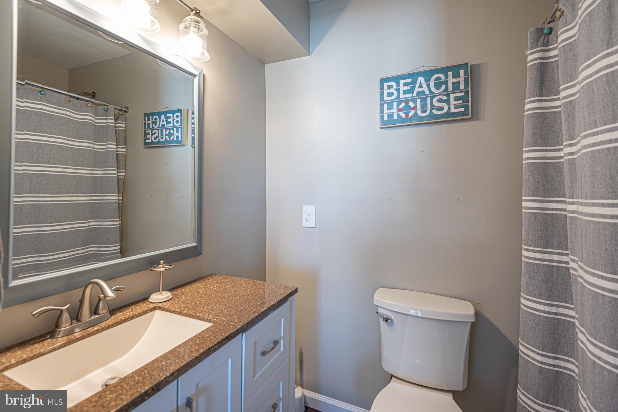 702 Bradley Road, Unit 11 Ocean City, MD 21842 - Photo 45 of 92 a bathroom with a granite countertop toilet and a sink