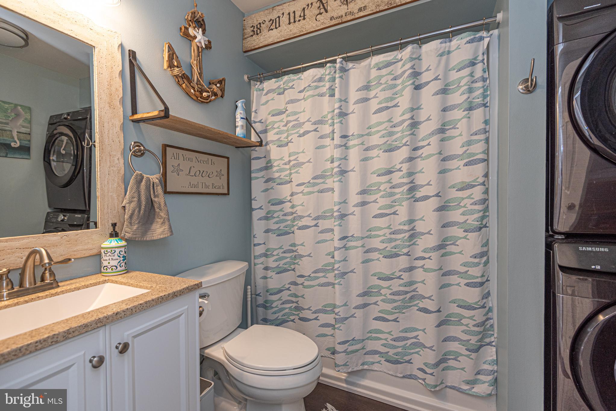 702 Bradley Road, Unit 11 Ocean City, MD 21842 - Photo 51 of 92 a bathroom with a toilet a sink and a shower curtain
