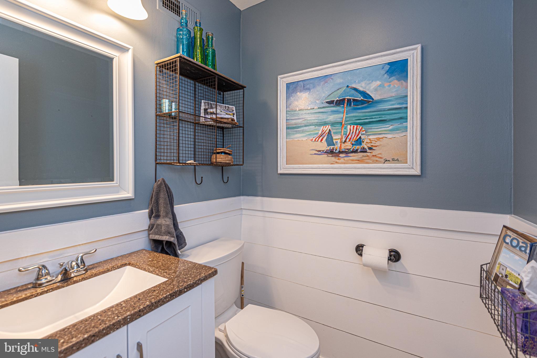 702 Bradley Road, Unit 11 Ocean City, MD 21842 - Photo 6 of 92 a bathroom with a granite countertop sink a toilet and a mirror
