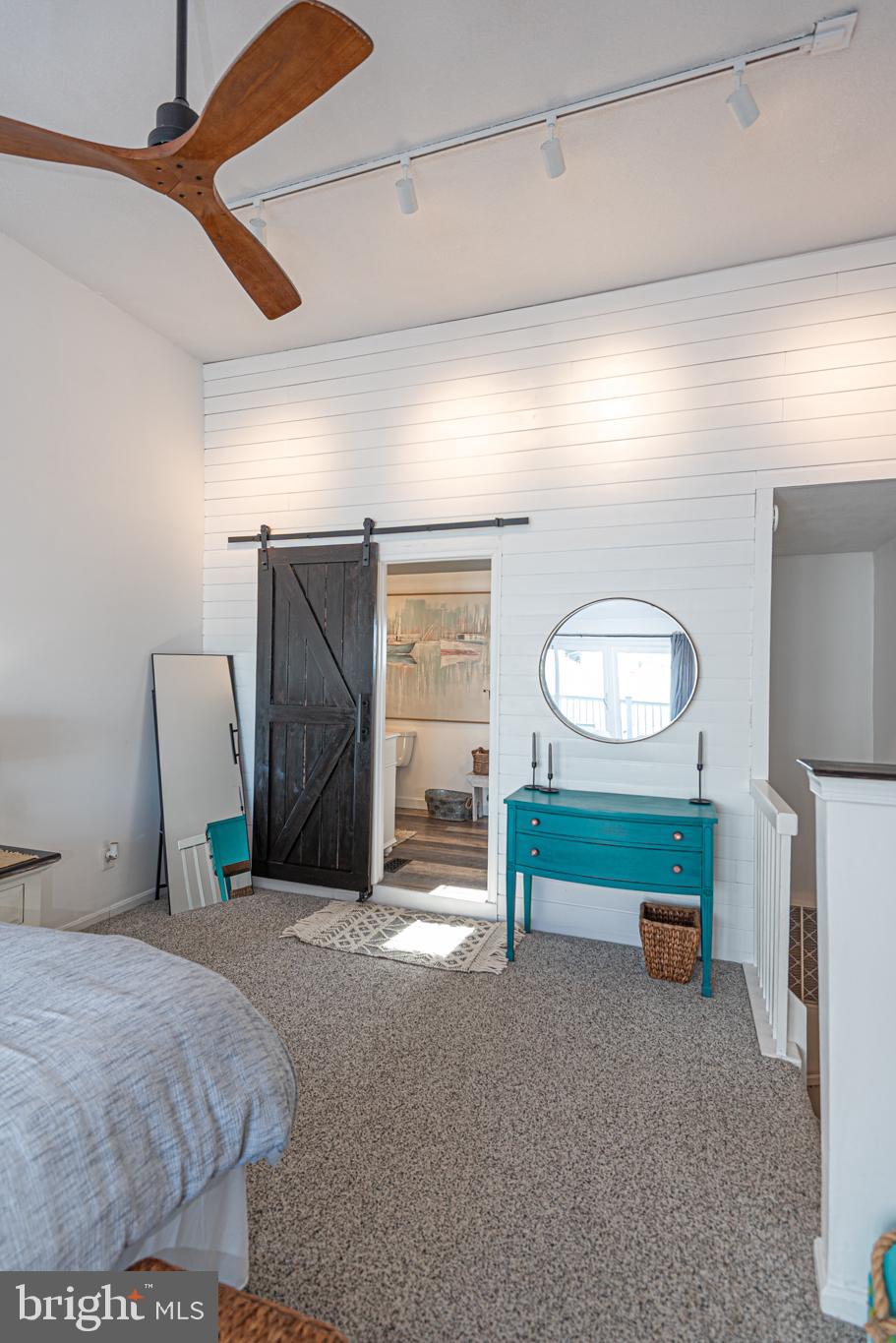 702 Bradley Road, Unit 11 Ocean City, MD 21842 - Photo 61 of 92 a bedroom with a bed and a mirror