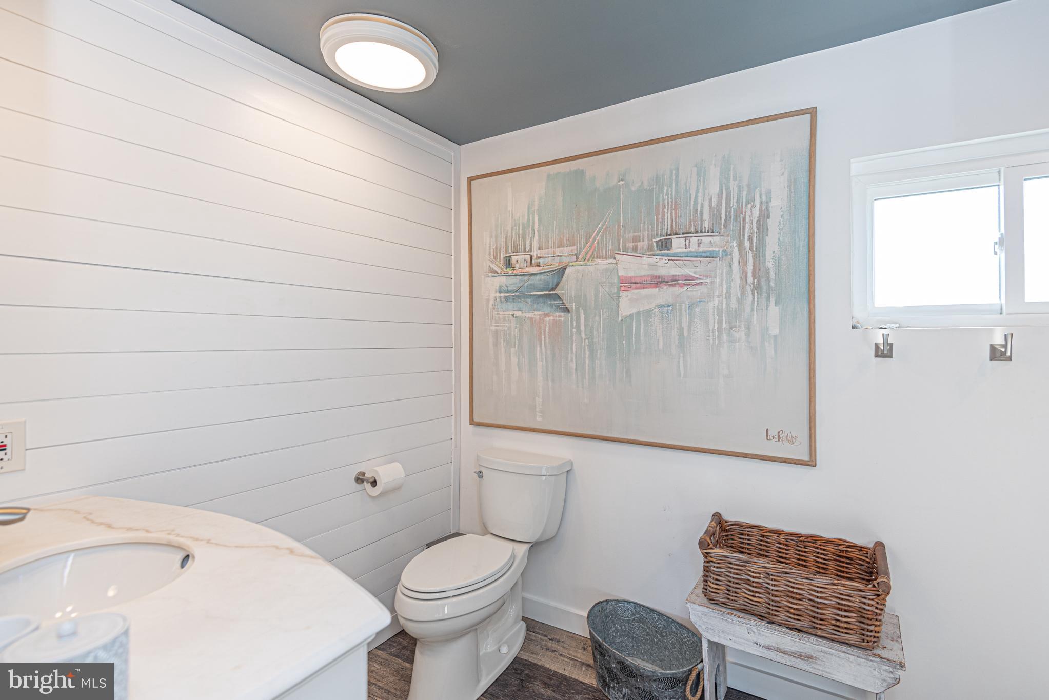 702 Bradley Road, Unit 11 Ocean City, MD 21842 - Photo 62 of 92 a bathroom with a toilet a sink and mirror