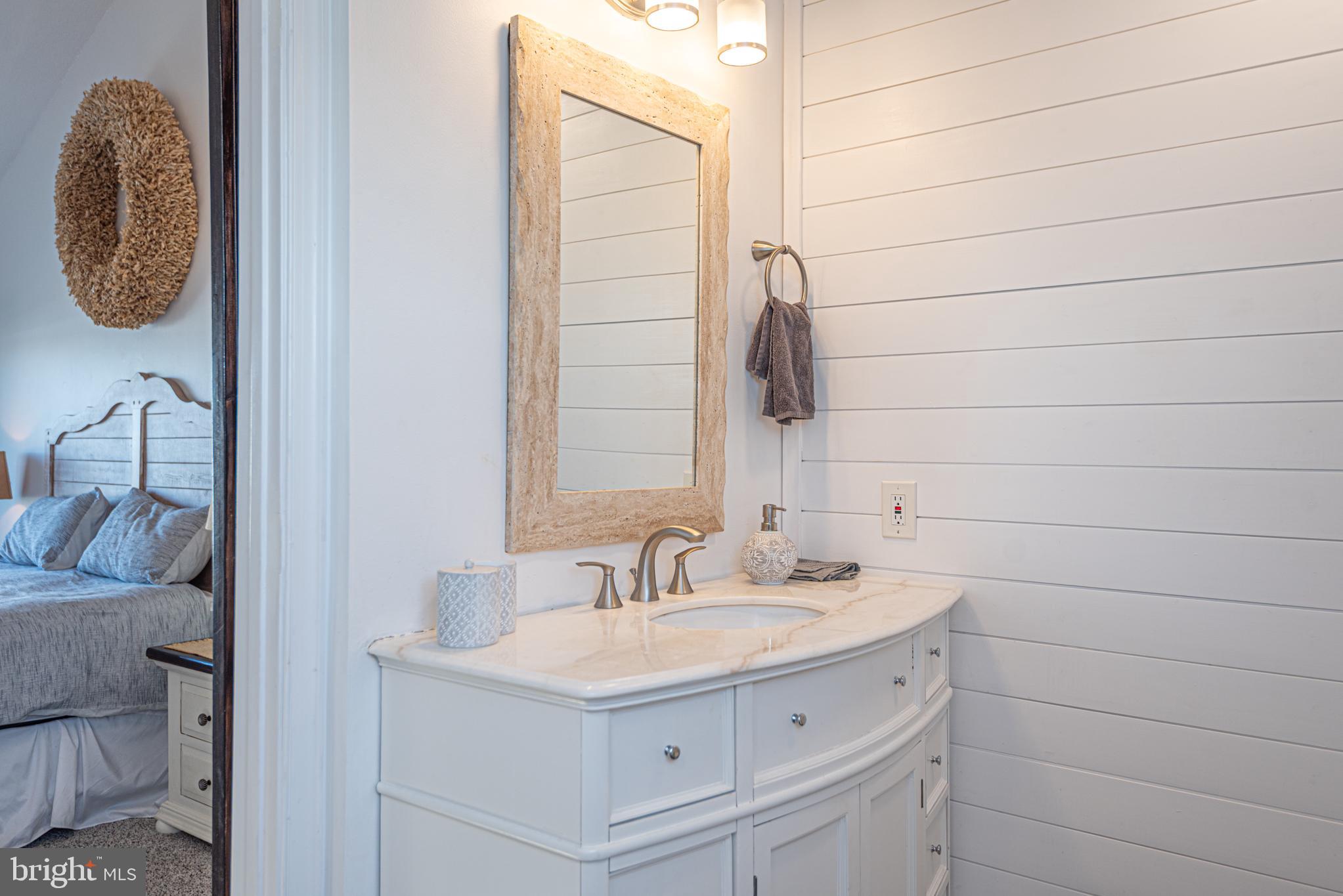702 Bradley Road, Unit 11 Ocean City, MD 21842 - Photo 64 of 92 a bathroom with a sink and a mirror