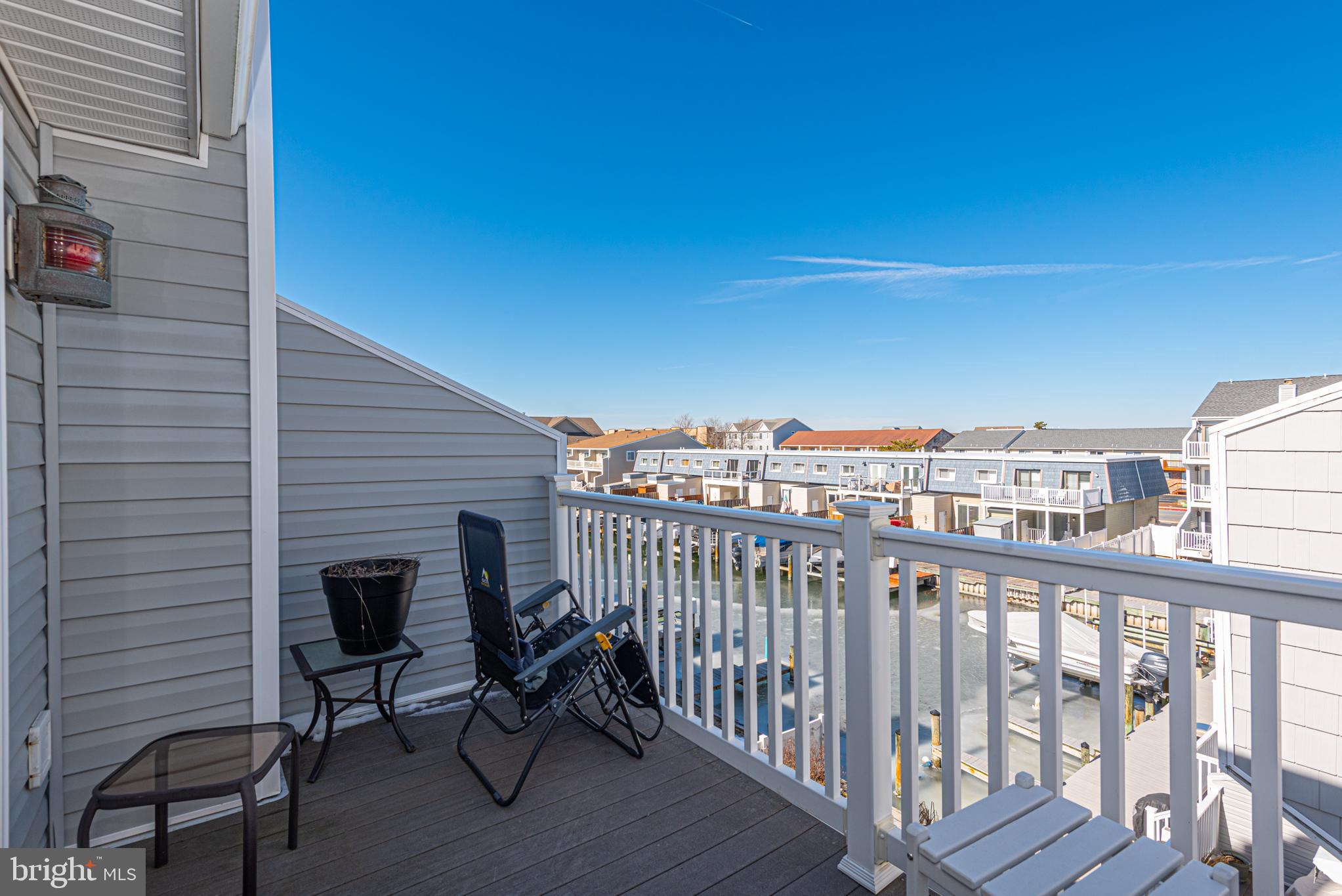 702 Bradley Road, Unit 11 Ocean City, MD 21842 - Photo 73 of 92 a view of a balcony with chair and wooden floor
