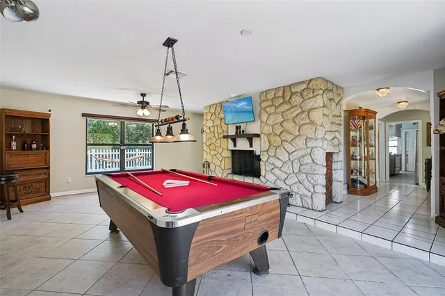 a kitchen with stainless steel appliances kitchen island granite countertop a refrigerator and a stove